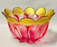 Side view of the scalloped tulip glass bowl showing red to yellow gradient coloration and petal shaping