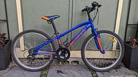 Full side view of the blue and orange Garneau youth bicycle with 24-inch wheels