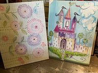 Both pastel mixed media paintings side by side on floor showing front view and colors