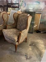 Full view of the floral fabric wing back chair