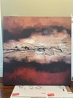 Full view of square canvas print artwork with abstract design in reddish brown, black, beige, and orange hues.