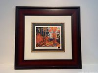 Front view of the entire framed print showing the brown-red outer frame and white matting.