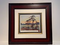 Framed print of The Jack Pine by Tom Thomson showing full frame and matting.