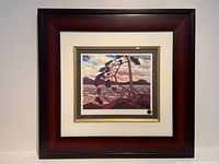 Front view of the framed print in a wooden dark reddish-brown frame with cream and gold matting.
