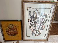 Photo of both framed art pieces together showing size difference and framing details.