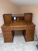Front view of antique oak library desk with two-part base and hutch