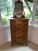 Front view of antique oak tall chest with attached mirror showing five drawers