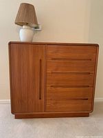 Front view of teak Danish Modern bureau with lamp on top