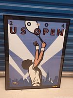 Framed 2004 US Open tennis tournament poster showing full artwork with player and background details.