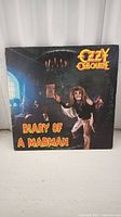 Front cover of the Ozzy Osbourne 'Diary of a Madman' vinyl record sleeve featuring the artist and album title with gothic artwork.