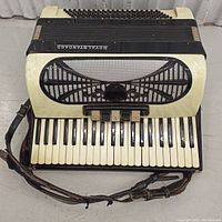 Front view of Royal Standard accordion showing keyboard, bass buttons, grille, and attached strap.