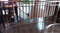 Full view of chrome frame console table with glass top positioned in room