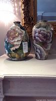 Both vases side by side on mantle