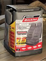 Photo showing front of genuine Dickies car seat covers package with branding, features, and product image.