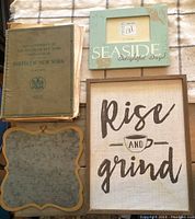 Overview photo showing Birds of New York book, Rise and Grind framed wall art, and decorative picture frame