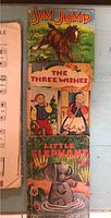 Photo showing three vintage children's books: 'Jim Jump,' 'The Three Wishes,' and 'Little Elephant' with illustrated covers and worn edges.