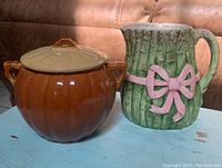 Soup tureen and asparagus pitcher placed side by side.