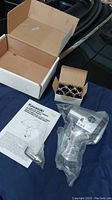 Full lot showing Kawasaki air impact wrench in original plastic bag, instruction manual, impact sockets in small box, and packaging box.
