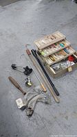 Photo showing tackle box, fishing rods, reel and fishing accessories on concrete floor