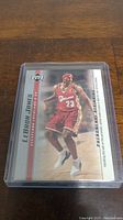 Photo of LeBron James rookie basketball card featuring him in Cleveland Cavaliers jersey, card encased in protective case.