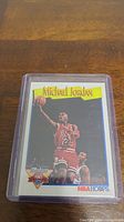 Photo of 1991 NBA Hoops Michael Jordan basketball card featuring Jordan in Bulls uniform, number 23, in protective case