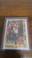 A single Michael Jordan basketball card featuring him in action during an East All-Star game, displayed in a protective plastic sleeve.