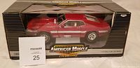 Front view of the boxed diecast model car showing red 1969 Shelby GT-500 with white stripes in American Muscle packaging.