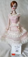 Front view of the 1991 Barbie Porcelain Plantation Belle Doll wearing a pink polka dot dress with lace and pearl accessories without box or shoes.