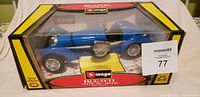 Photo of Burago Bugatti Type 59 die-cast car in original yellow and black box with clear window showcasing blue race car model inside.