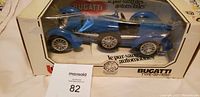 Photo of the Burago Bugatti Type 59 1:18 scale model car in original packaging, showing blue diecast model and box with some shelf wear.