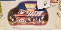 Figurine of Dept 56 Gus's Drive-In, showing retro style diner with signage and awning