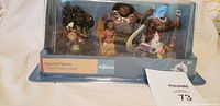 Photo showing the full sealed Disney Moana Figurine Playset in blister packaging with all seven figurines visible.