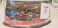 Clear plastic packaging containing six Disney Planes character airplane figurines including Dusty Crophopper and others, labeled MaxSold 71