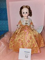 Front view of Elizabeth Monroe Madame Alexander First Lady doll seated in original pink box with certificate visible.