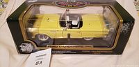 Front view of boxed yellow 1955 Ford Thunderbird die-cast model car in new condition.