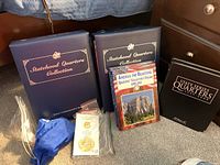 Overview of coin albums, folder, tokens in bags, and drawstring bag of loose coins