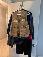 Photo showing Expedition sportsman's gear vest hanging in front of other jackets