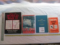 Four books laid out horizontally, titles visible on front covers.