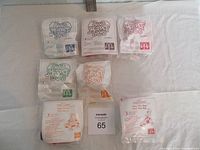 Photo of 7 sealed McDonald's Muppet Babies collectible toys in original plastic bags, showing front side with logos and text.