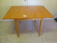 Hamilton and Spill maple drop-leaf table fully extended showing wood grain top and rectangular shape with leafs extended.