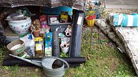 Full lot displayed showing ceramic planter, black plastic rolls, watering jug, seed packets, jiffy pots, jute rolls, and other gardening items.