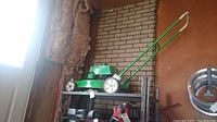 Side view of mower on shelf showing deck and wheels
