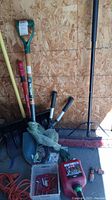 Overview of the gardening tools including push broom, shovels, rake, loppers, gloves, extension cord, and gas can.