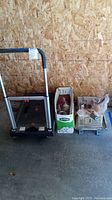 Photo showing overall lot including flatform truck and two boxes with painting tools and paint cans