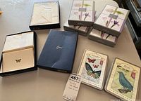 Lot of Cranes stationery and hallmark notecards on table - includes boxed floral notecards, open box with stationery sheets, and hallmark notecard tins