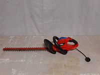 Front side view of the Black & Decker Hedge Hog electric hedge trimmer showing the full length blade, hand guard and ergonomic handles.