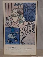 Front view of the framed Henri Matisse retrospective poster featuring colorful artwork of vases and abstract shapes, showing the entire piece.