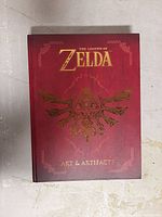 Front cover of The Legend of Zelda: Art & Artifacts book showing title and embossed gold design.