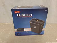 Box of a Staples 8-sheet cross-cut paper shredder labeled medium duty.