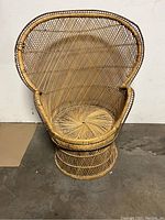 Full front view of peacock style rattan chair showing overall shape, size and condition